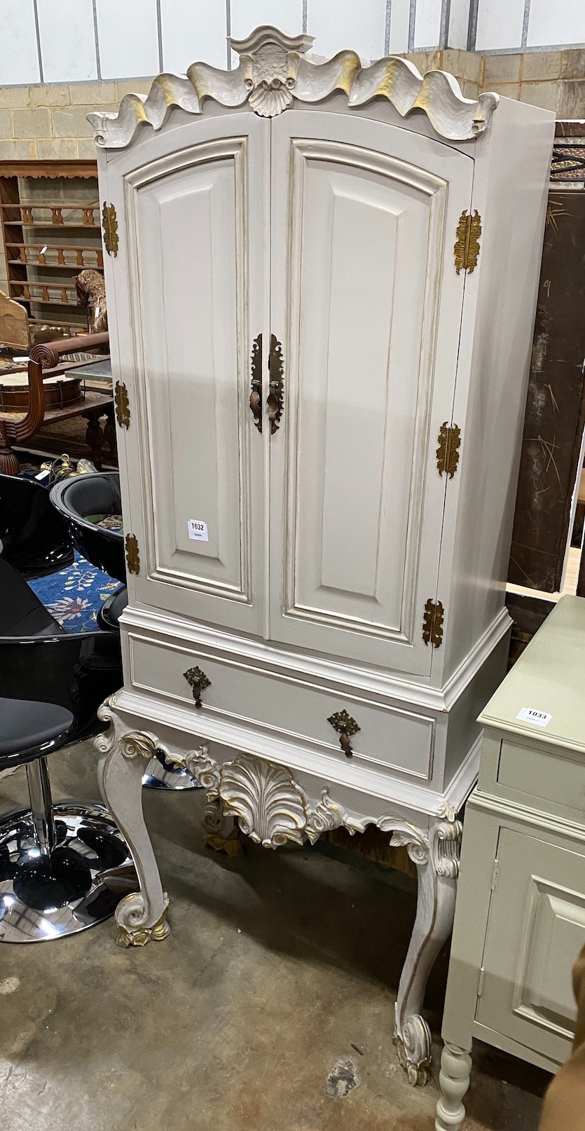 A French grey painted hardwood cocktail cabinet, with parcel gilt decoration, width 75cm height 175cm